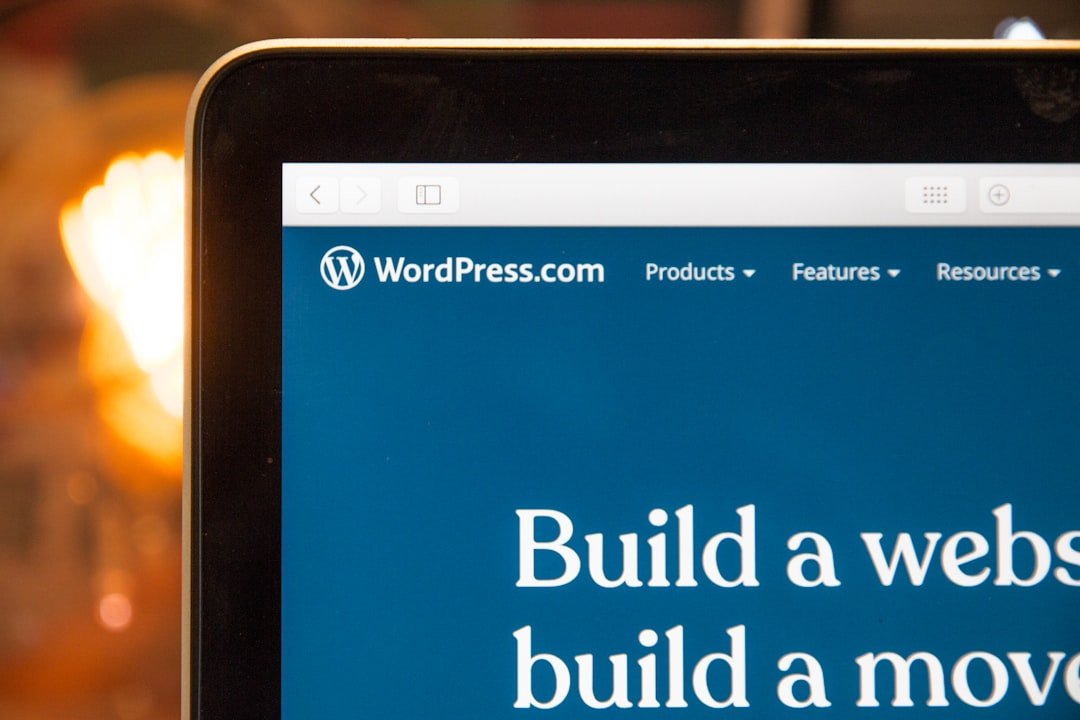 Close-up of a computer screen displaying the WordPress.com website. The text on the screen reads, "Build a website, build a movement.