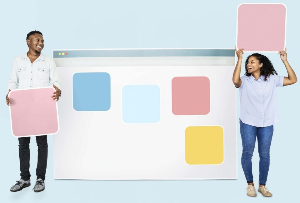 Two people stand in front of a large mockup of a web browser, each holding a pastel-colored square resembling a UI element—an inspiring nod to The Future of Web Design: 10 Trends That Will Dominate in 2025.
