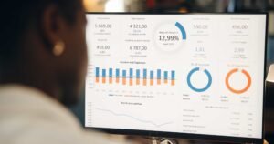 A person views a computer screen displaying financial dashboards with charts, graphs, and data summaries on income, expenses, and performance metrics. How to Add Google Analytics to Your WordPress Site