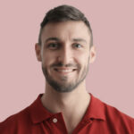 Home A man with short brown hair and a trimmed beard, wearing a red polo shirt, smiles at the camera against a plain pink background, reflecting the approachable style often seen in NYC Web Design and SEO profiles.