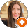 Home A woman with long brown hair smiles at the camera; the image is in a circular frame with an orange star badge at the bottom right, representing NYC Web Design and SEO expertise.