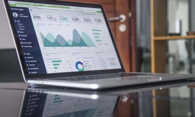 6 SEO Mistakes to Avoid in 2023 A laptop on a glass table displays a business analytics dashboard with graphs, charts, performance metrics, and seo insights.