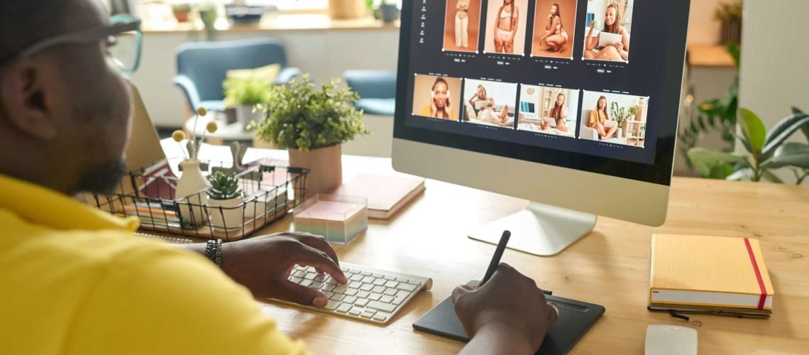A person using a stylus and tablet edits photos of a woman in various poses on a desktop computer, illustrating one of the 7 Reasons Your Business Absolutely Needs a Website in 2025, all within a well-lit office space.