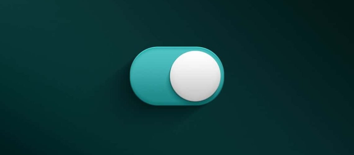 A teal toggle switch set to the "on" position against a dark green background.